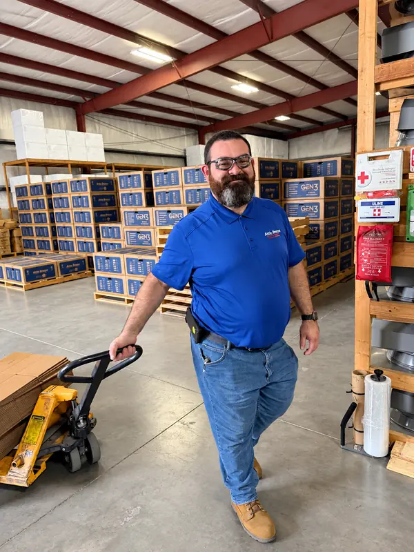 Attic Breeze team member moving product in the warehouse