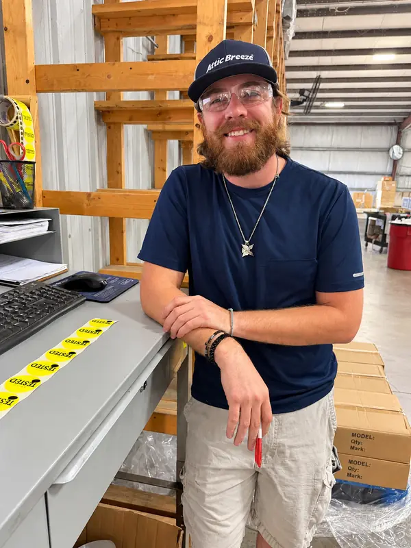 Attic Breeze team member at a fan testing station