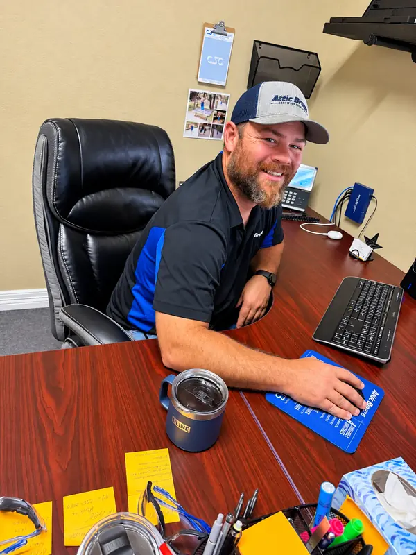Attic Breeze team member at his desk